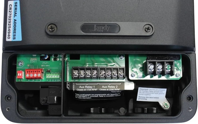 Jandy R0974400 drive wiring compartment open showing Aux Relay 1 and Aux Relay 2 terminal blocks and ground point